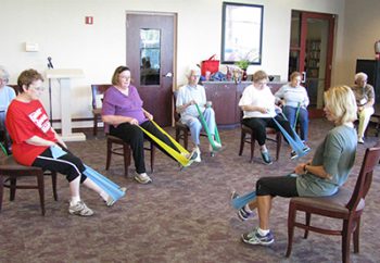 Exercise class stretching in chairs