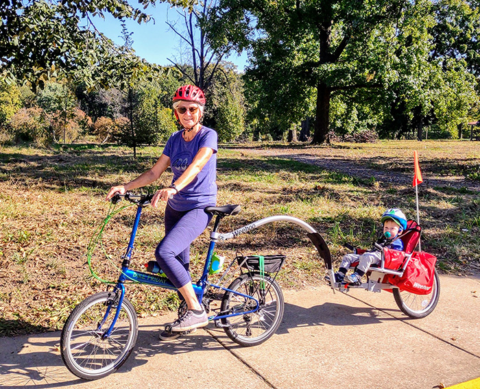 Janice Branham, above with her youngest biking buddy, retired in 2018 from her job as director of communications and technology at the Oasis Institute.