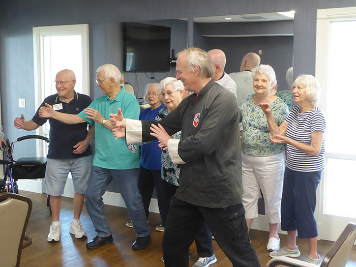 “We have fun and move!” says Margaret Olds of the Tai Chi classes led by longtime Oasis instructor George Gajdos at her senior community. Margaret is the third person from left.