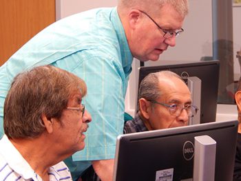 Tom Weaver helping participants in computer class